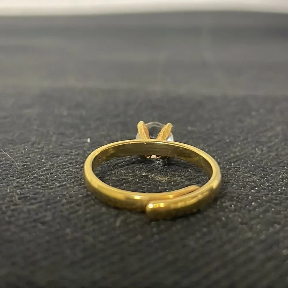 Adjustable band ring with a white gem